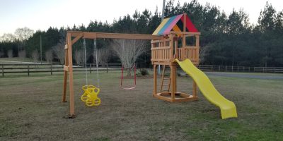 Wooden swingset with yellow slide